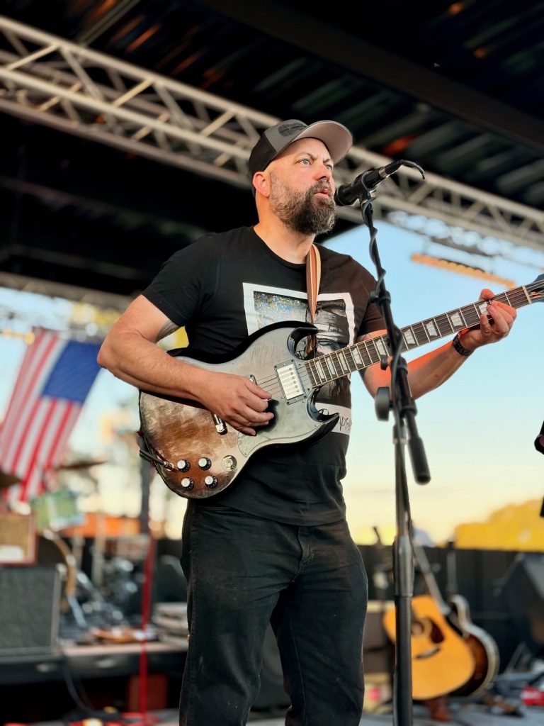 Brad Haefner playing guitar on stage
