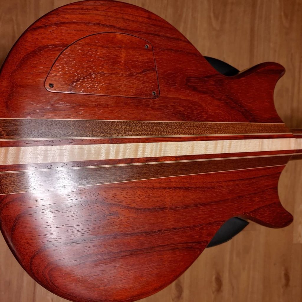 Back of the padauk guitar with maple binding stripe