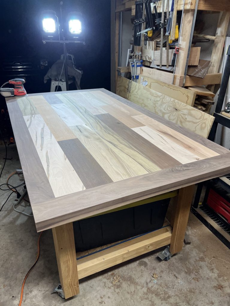 Patchwork hardwood table top with walnut border