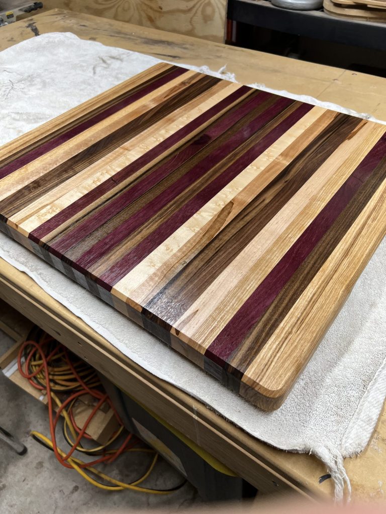Purpleheart, maple and walnut cutting board