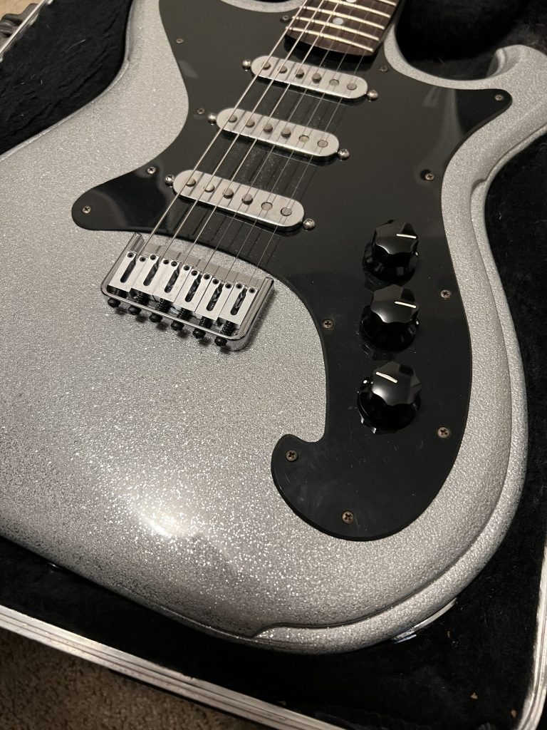 Silver sparkle electric guitar body and bridge