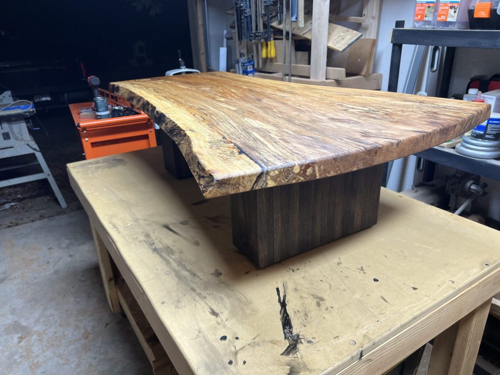 Spalted slab coffee table on a walnut base