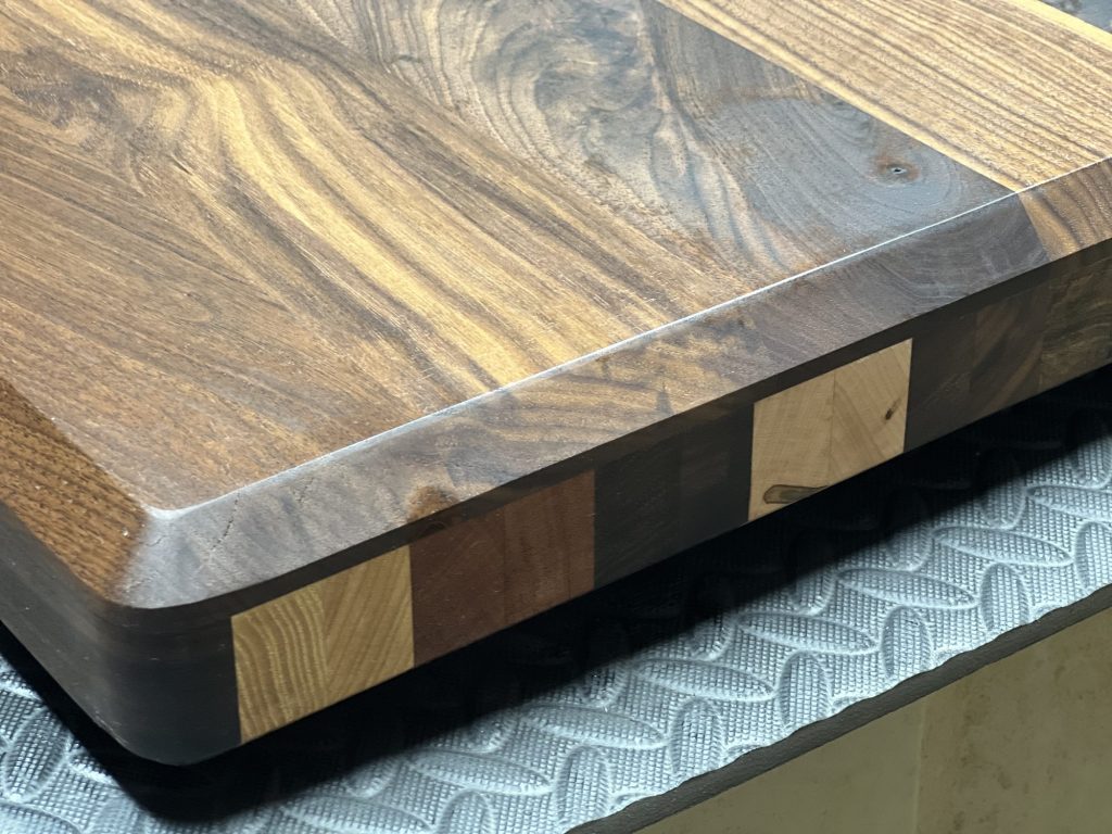 Rounded corner of a walnut cutting board